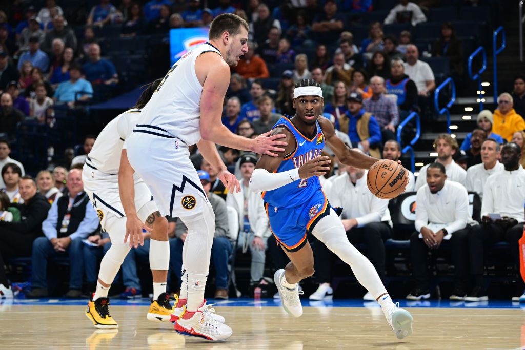 OKLAHOMA CITY, OKLAHOMA - OCTOBER 29: Shai Gilgeous-Alexander #2 of the Oklahoma City Thunder attempts to drive past Nikola Jokic #15 of the Denver Nuggets during the first quarter of a game at Paycom Center on October 29, 2023 in Oklahoma City, Oklahoma.