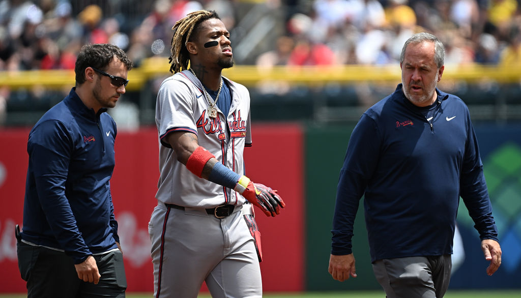 PITTSBURGH, PENNSYLVANIA - MAY 26: Ronald Acuña Jr. #13 of the Atlanta Braves walks off the field with trainers after an apparent injury in the first inning during the game against the Pittsburgh Pirates at PNC Park on May 26, 2024 in Pittsburgh, Pennsylvania