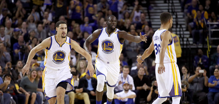 OAKLAND, CA - OCTOBER 04: Klay Thompson #11 and Stephen Curry #30 congratulate Draymond Green #23 of the Golden State Warriors after he made a basket against the Los Angeles Clippers during their preseason game at ORACLE Arena on October 4, 2016 in Oakland, California.