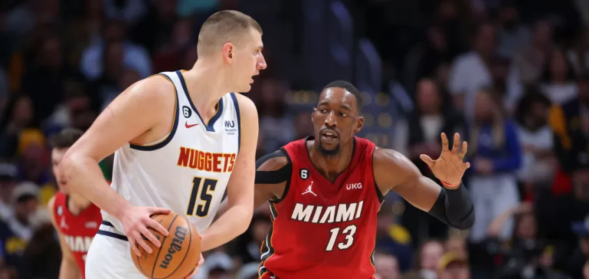 DENVER, CO - DECEMBER 30: Bam Adebayo #13 of the Miami Heat defends Nikola Jokic #15 of the Denver Nuggets during the first quarter at Ball Arena on December 30, 2022 in Denver, Colorado.