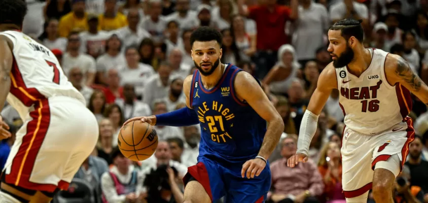 MIAMI, FL - JUNE 7: Jamal Murray (27) of the Denver Nuggets handles as Caleb Martin (16) of the Miami Heat defends in the fourth quarter of the Nuggets' 104-94 win during Game 3 of the NBA Finals at the Kaseya Center in Miami on Wednesday, June 7, 2023