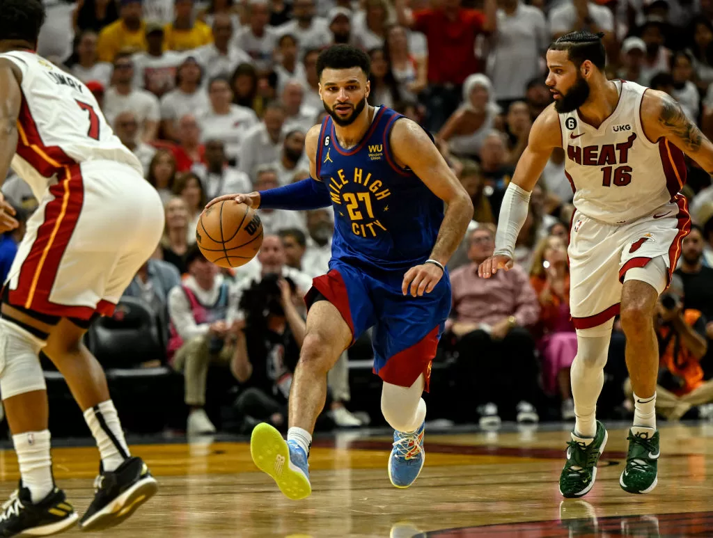 MIAMI, FL - JUNE 7: Jamal Murray (27) of the Denver Nuggets handles as Caleb Martin (16) of the Miami Heat defends in the fourth quarter of the Nuggets' 104-94 win during Game 3 of the NBA Finals at the Kaseya Center in Miami on Wednesday, June 7, 2023