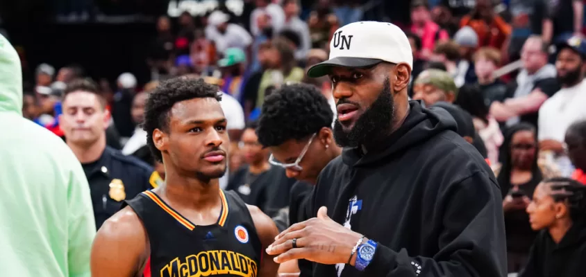 HOUSTON, TEXAS - MARCH 28: Bronny James #6 of the West team talks to Lebron James of the Los Angeles Lakers after the 2023 McDonald's High School Boys All-American Game at Toyota Center on March 28, 2023 in Houston, Texas.