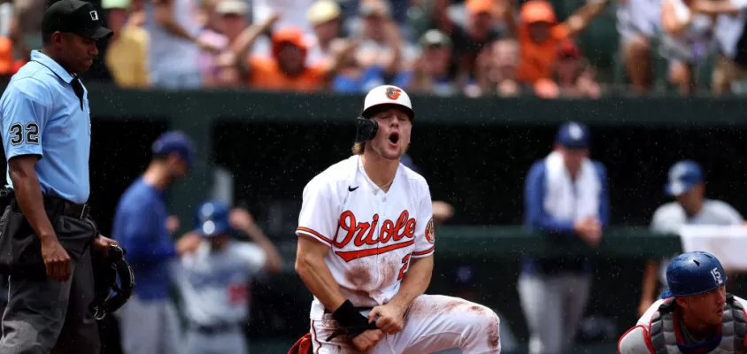 BALTIMORE, MARYLAND - JULY 19: Gunnar Henderson #2 of the Baltimore Orioles scores a run ahead of the tag of catcher Austin Barnes #15 of the Los Angeles Dodgers in the first inning at Oriole Park at Camden Yards on July 19, 2023 in Baltimore, Maryland.