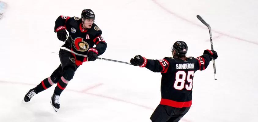 STOCKHOLM, SWEDEN - NOVEMBER 16: Jake Sanderson #85 and Tim Stutzle #18 of the Ottawa Senators react after Stutzle scored in the overtime period of the 2023 NHL Global Series in Sweden between the Detroit Red Wings and the Ottawa Senators at Avicii Arena on November 16, 2023 in Stockholm, Sweden.