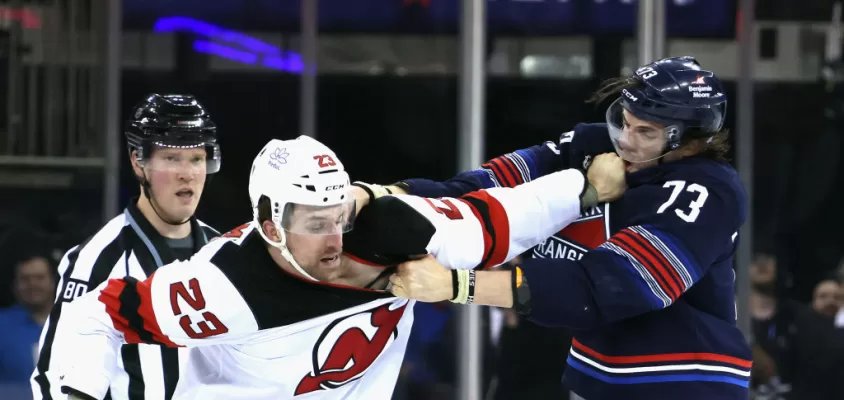 NEW YORK, NEW YORK - APRIL 03: Kurtis MacDermid #23 of the New Jersey Devils fights with Matt Rempe #73 of the New York Rangers during the first period at Madison Square Garden on April 03, 2024 in New York City