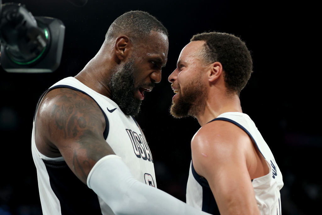 PARIS, FRANCE - AUGUST 08: Lebron James #6 and Stephen Curry #4 of Team United States celebrate after their team's win against Team Serbia during a Men's basketball semifinals match between Team United States and Team Serbia on day thirteen of the Olympic Games Paris 2024 at Bercy Arena on August 08, 2024 in Paris, France.